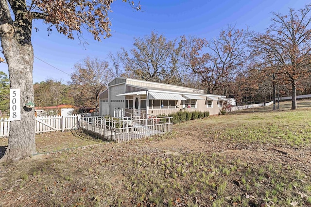 back of property with covered porch and a garage