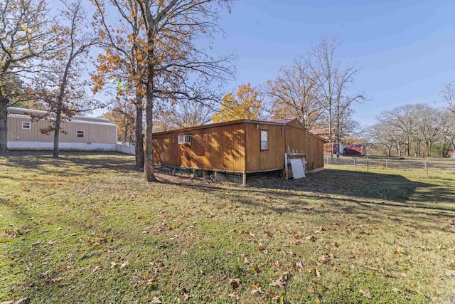 exterior space with an outbuilding and a lawn