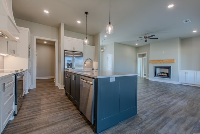 kitchen with white cabinetry, sink, hanging light fixtures, a center island with sink, and appliances with stainless steel finishes