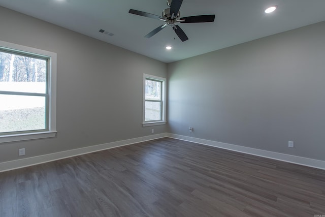 empty room featuring ceiling fan and dark hardwood / wood-style flooring