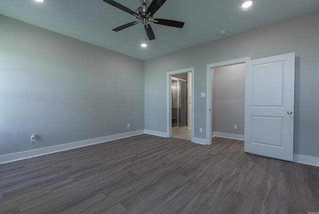 unfurnished bedroom featuring dark hardwood / wood-style flooring, ensuite bath, and ceiling fan