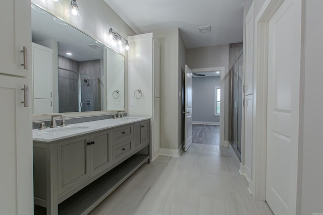 bathroom featuring vanity and a shower with shower door