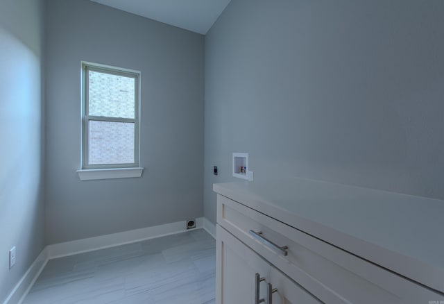 laundry area featuring washer hookup, electric dryer hookup, and cabinets