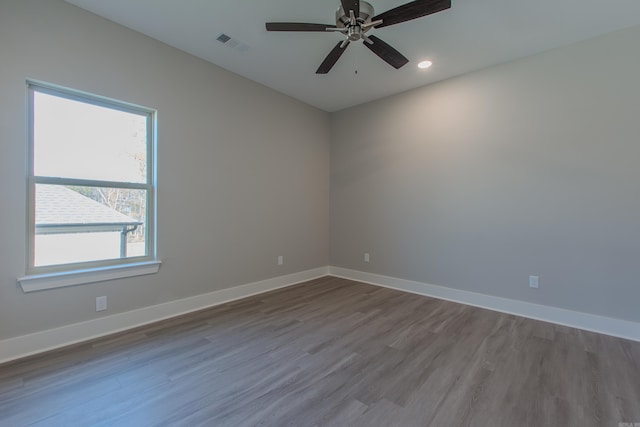 unfurnished room with ceiling fan, plenty of natural light, and hardwood / wood-style flooring