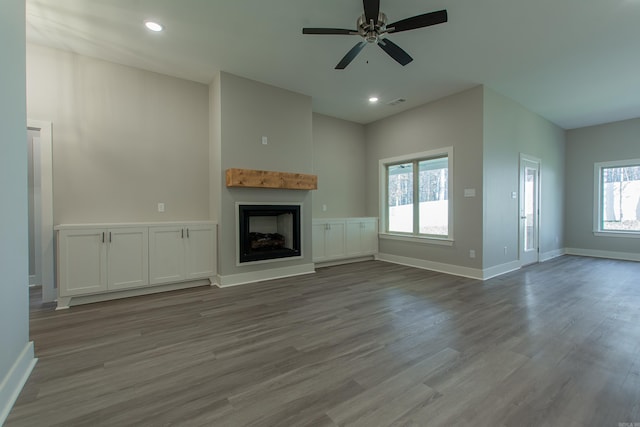 unfurnished living room featuring light hardwood / wood-style floors and ceiling fan