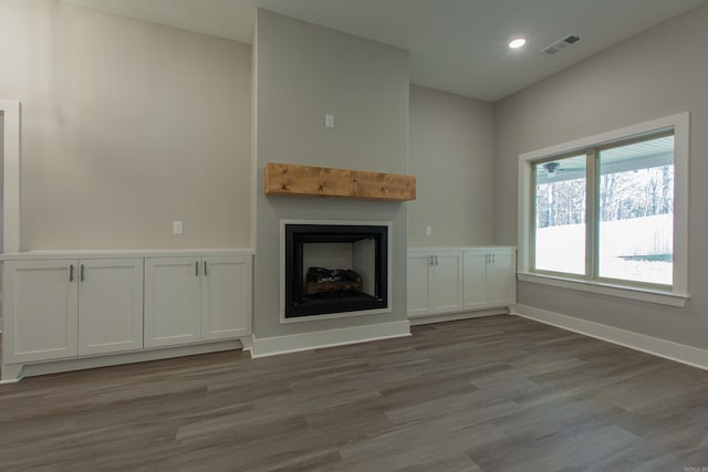 unfurnished living room with wood-type flooring