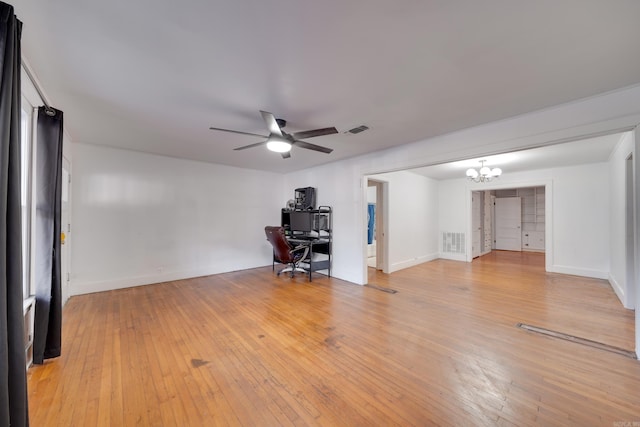 unfurnished office featuring light hardwood / wood-style floors and ceiling fan with notable chandelier