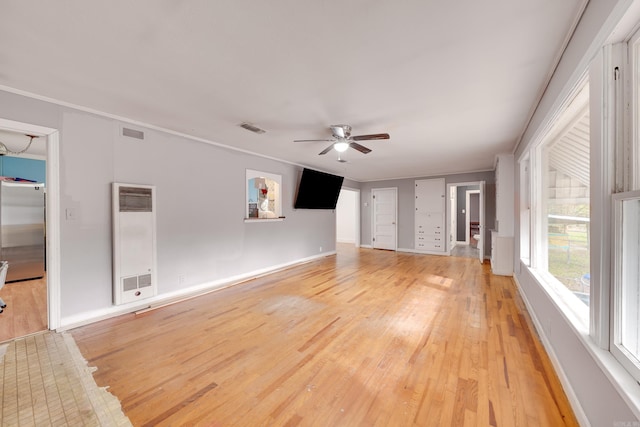 unfurnished living room featuring light wood-type flooring, ceiling fan, and crown molding