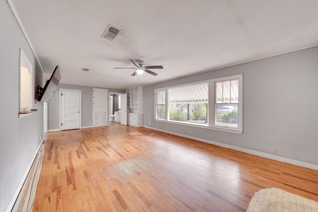 unfurnished living room featuring ceiling fan, light hardwood / wood-style floors, ornamental molding, and a baseboard heating unit