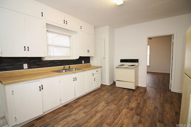 kitchen featuring dark hardwood / wood-style flooring, electric range, white cabinetry, and sink