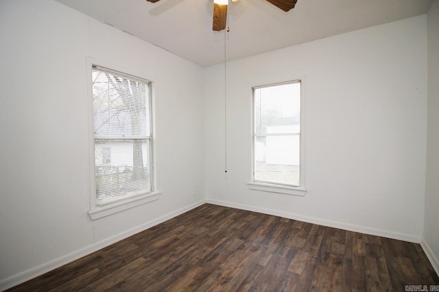 spare room with ceiling fan, dark wood-type flooring, and a healthy amount of sunlight