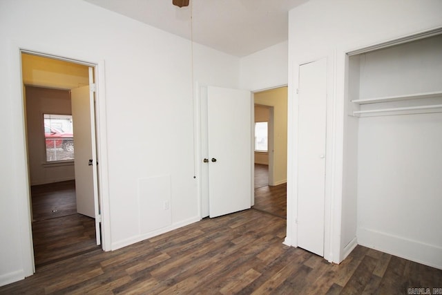 unfurnished bedroom with a closet and dark hardwood / wood-style flooring