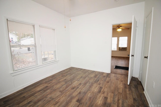 unfurnished room with ceiling fan and dark hardwood / wood-style flooring