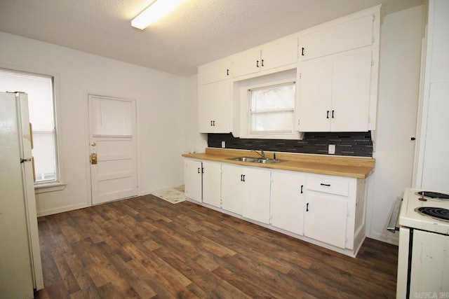 kitchen featuring white cabinets, white appliances, and sink