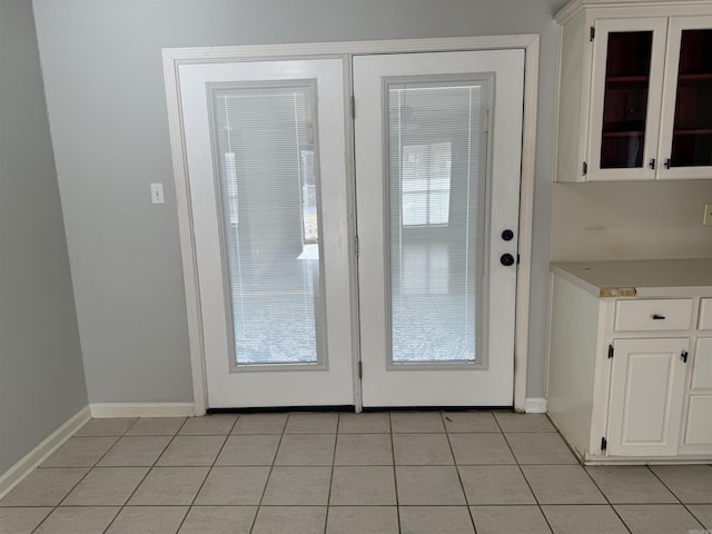 entryway with light tile patterned floors