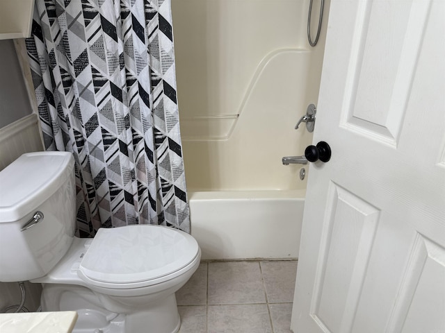 bathroom featuring tile patterned floors, toilet, and shower / bathtub combination with curtain