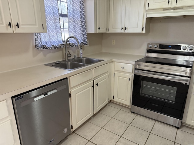 kitchen featuring white cabinets, light tile patterned flooring, sink, and stainless steel appliances