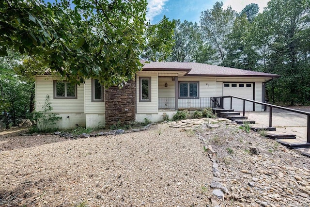 ranch-style house with covered porch and a garage