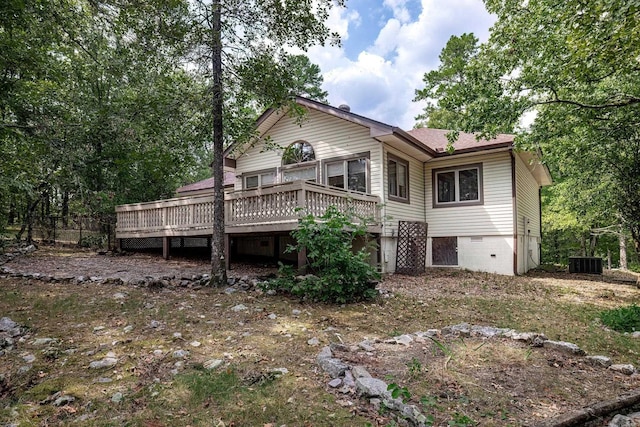 rear view of property featuring a wooden deck and central AC