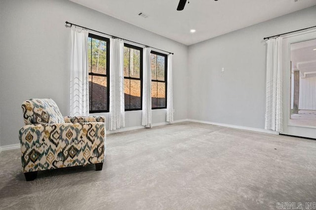 sitting room with carpet flooring and ceiling fan