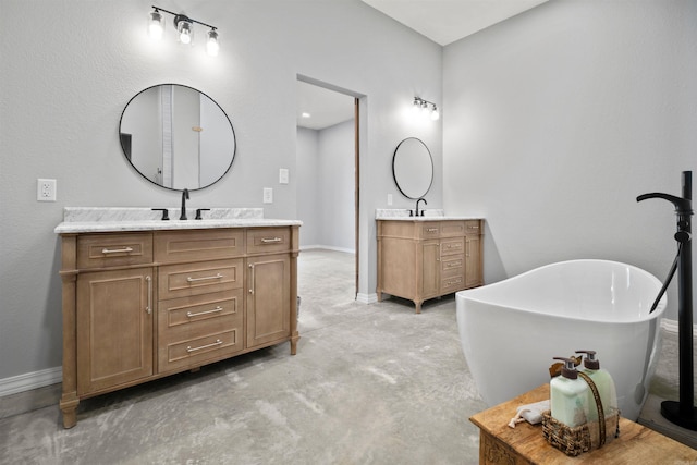 bathroom with vanity and a tub