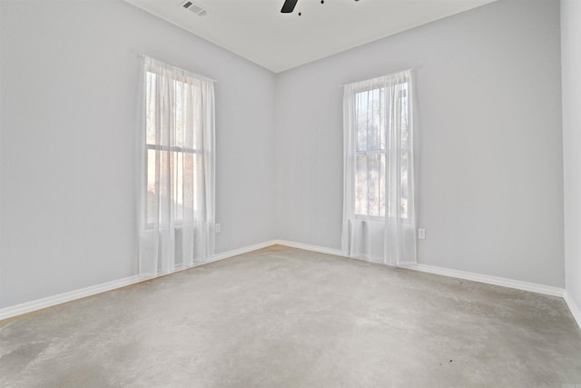 spare room with ceiling fan and a healthy amount of sunlight