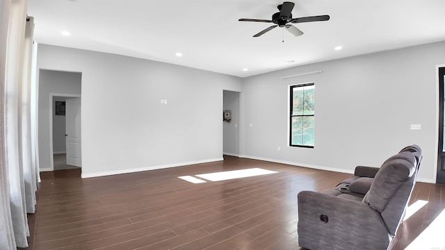 unfurnished room with ceiling fan and dark hardwood / wood-style flooring