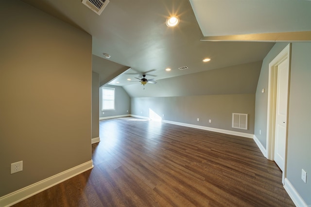 additional living space featuring dark hardwood / wood-style floors, vaulted ceiling, and ceiling fan