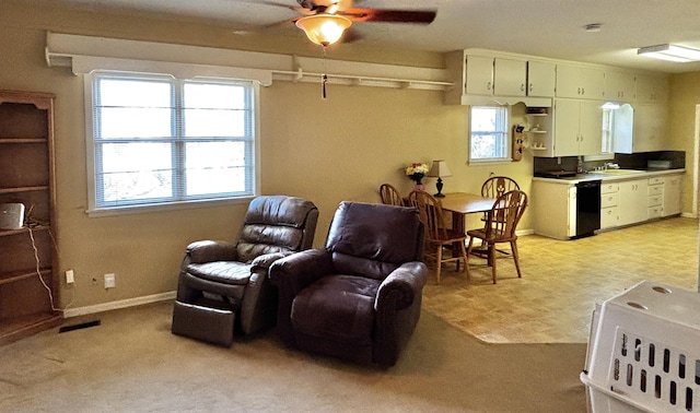 living room with light colored carpet, ceiling fan, and sink