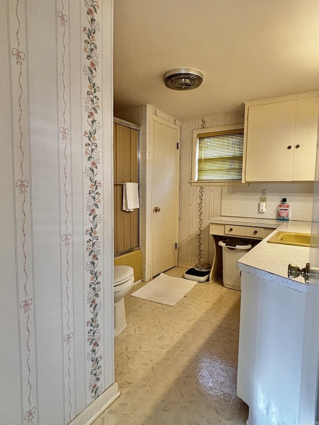 kitchen featuring white cabinetry and sink