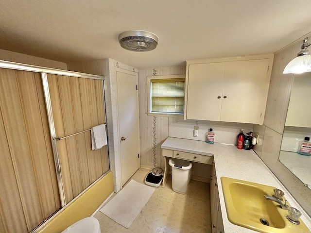 bathroom featuring vanity and enclosed tub / shower combo