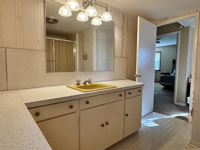 bathroom with a shower with door and vanity