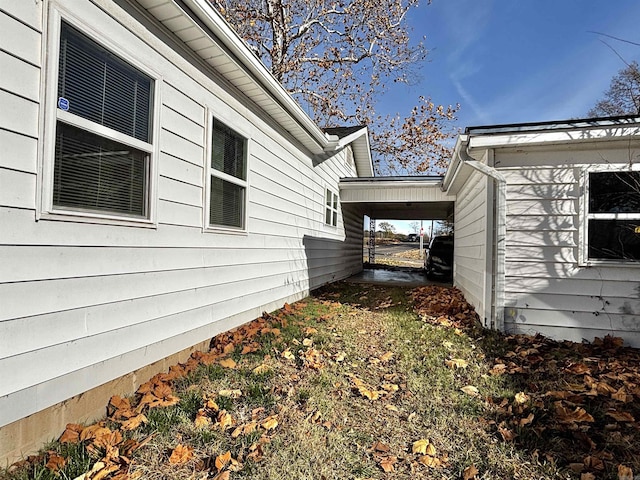 view of property exterior with a carport