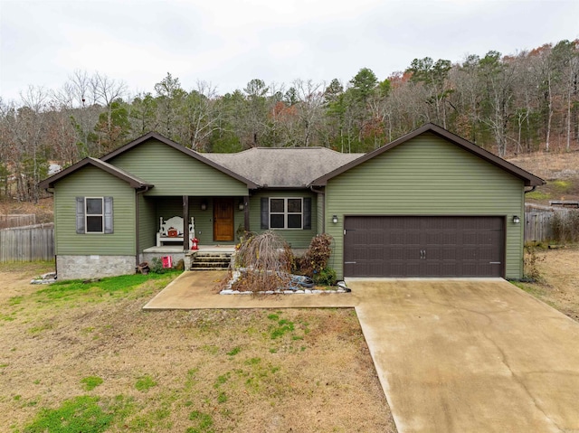 single story home with a front yard, a porch, and a garage