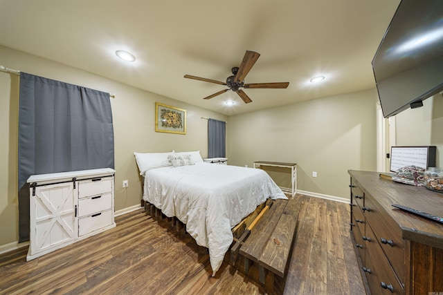 bedroom with dark hardwood / wood-style flooring and ceiling fan