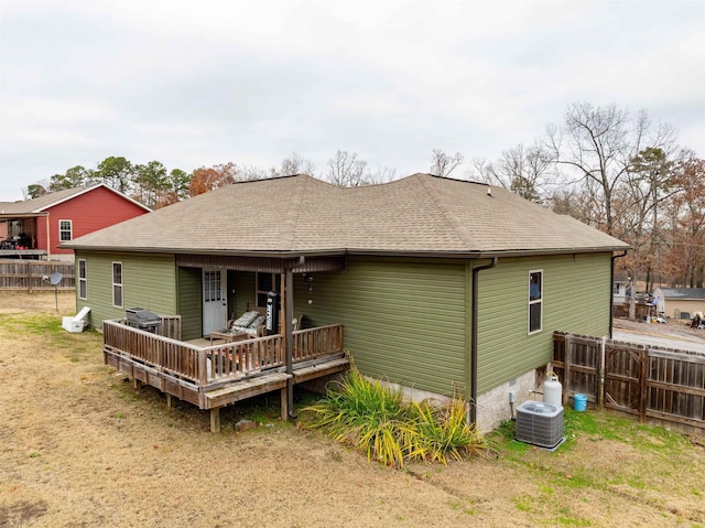 back of house featuring a yard, cooling unit, and a deck