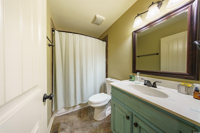 full bathroom featuring shower / bathtub combination with curtain, vanity, and toilet