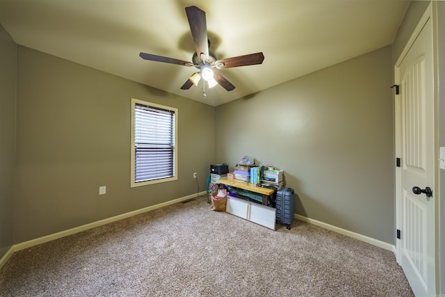 interior space with carpet flooring and ceiling fan