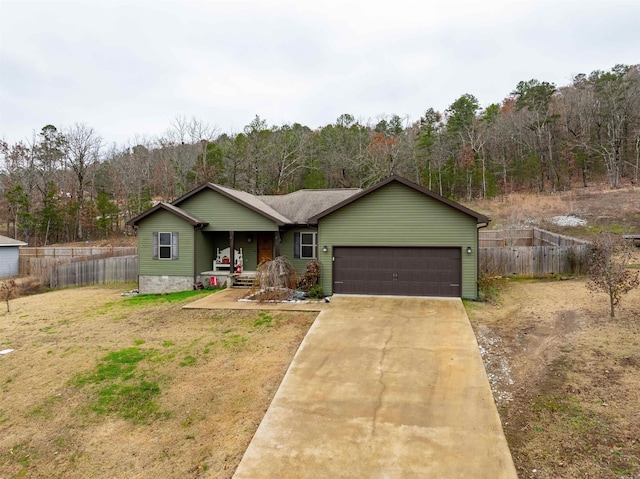 ranch-style house featuring a porch, a garage, and a front yard