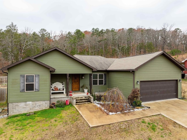 ranch-style home with a front yard, a porch, and a garage