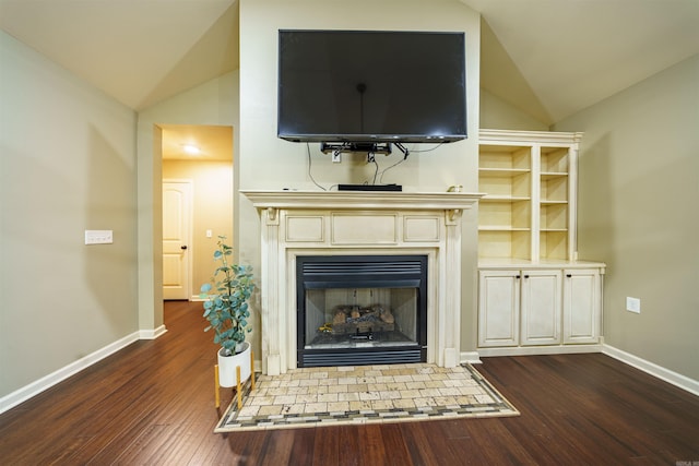 unfurnished living room with dark hardwood / wood-style floors and vaulted ceiling