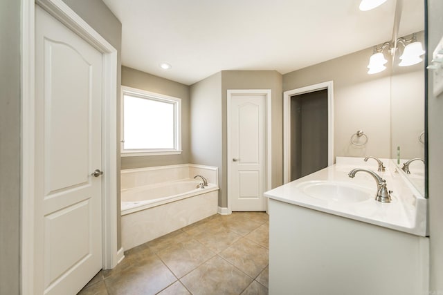 bathroom featuring tile patterned floors, a bathtub, vanity, and a chandelier