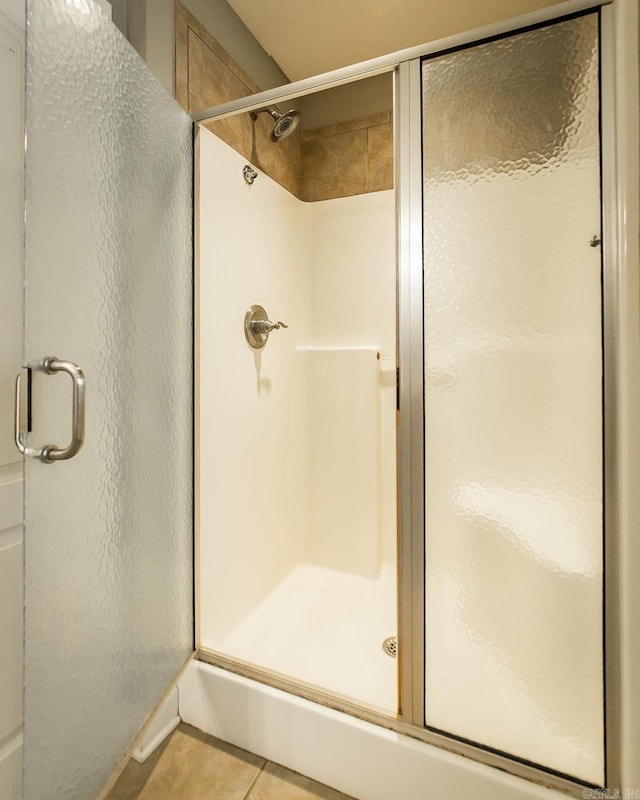 bathroom featuring tile patterned flooring and a shower with door