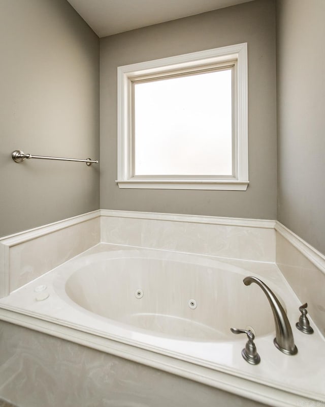 bathroom featuring a tub to relax in and a wealth of natural light