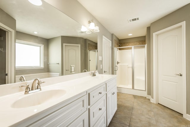 bathroom with tile patterned flooring, vanity, and an enclosed shower