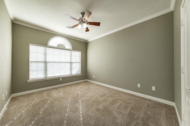 carpeted spare room with ceiling fan, ornamental molding, and a textured ceiling