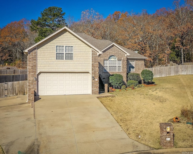 view of front of house featuring a garage and a front yard