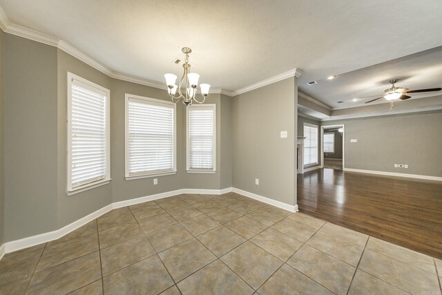 empty room with a textured ceiling, ceiling fan with notable chandelier, crown molding, and light hardwood / wood-style flooring