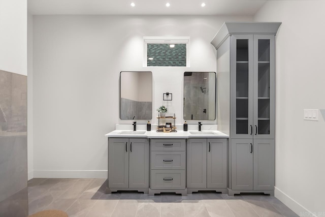 bathroom featuring tile patterned flooring, vanity, and walk in shower