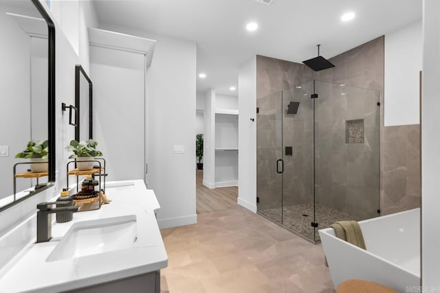 bathroom with separate shower and tub and vanity